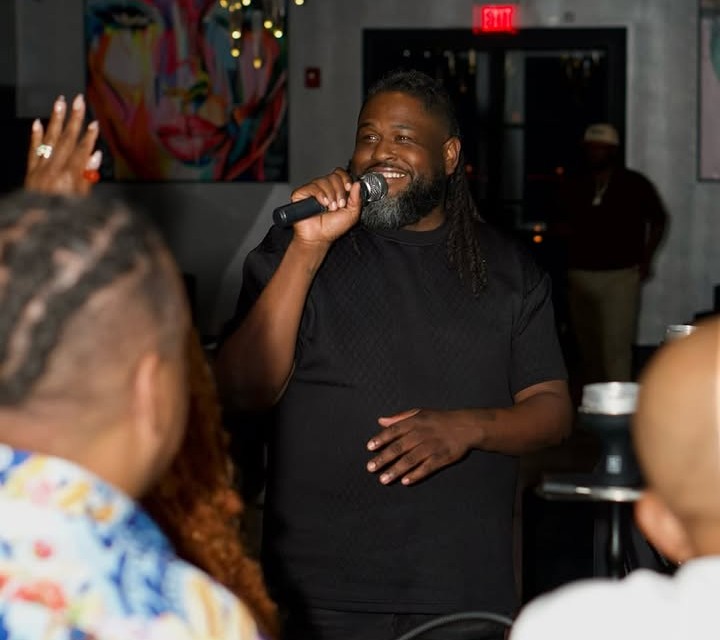 Host singing karaoke with the crowd at Tech & Tunes